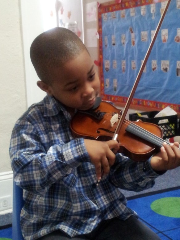 Ivan shows his form during a class on proper bowing technique.