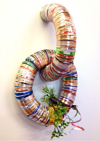 "Quetzal sittin’..." by Sarah Crooks Flaire, recycled aluminum , vhs tape, and plastic greenery 22”x13”x4”